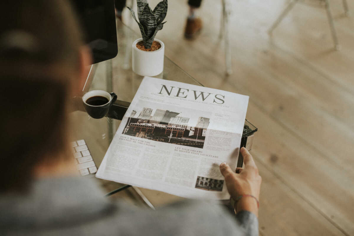 Businessman on his desk with a newspaper