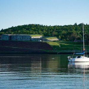 A boat sailing in Penobscot River in front of Fort Knox State Park, Prospect, Maine